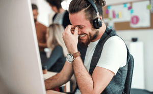 young-businessman-with-headphones-and-colleagues-i-2021-08-26-12-09-24-utc-min